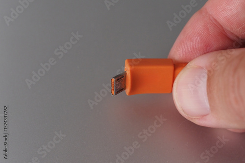Broken orange USB connector. Clopy space.