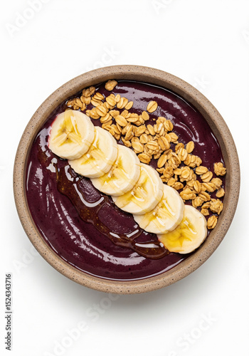 Açaí bowl with banana and granola, top view isolated on white