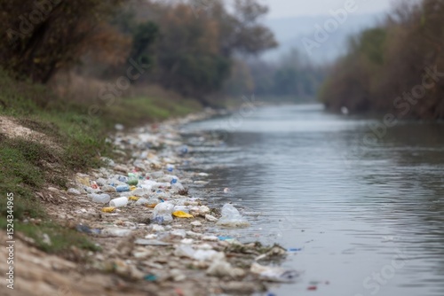 Shimmering detritus sprawls along a mist-veiled riverside, evoking Earth Day reflections and melancholy urban sustainability reveries