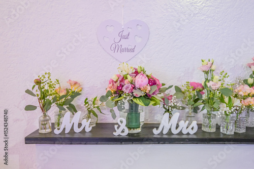 Wedding decor. Close up of a wedding table decoration with white and pink flowers and candles Wedding floristic concept