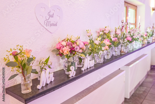Wedding decor. Close up of a wedding table decoration with white and pink flowers and candles Wedding floristic concept