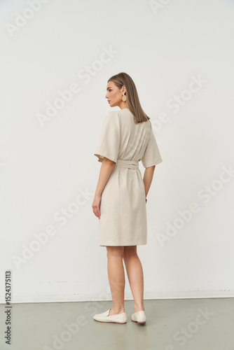 Elegant model showcasing contemporary fashion in a stylish indoor studio setting