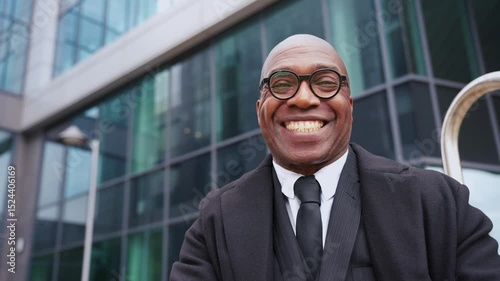 Wallpaper Mural Confident professional man posing outside modern office building on a clear day in the city Torontodigital.ca
