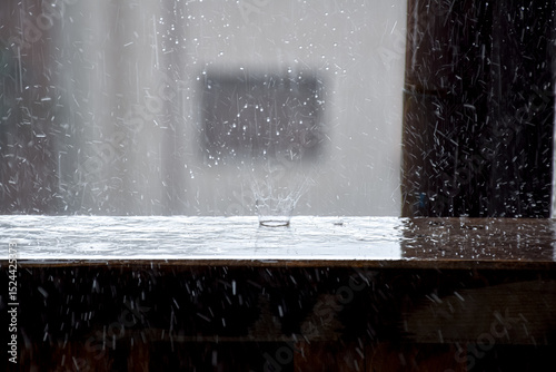 Raindrop Splash on Window Sill