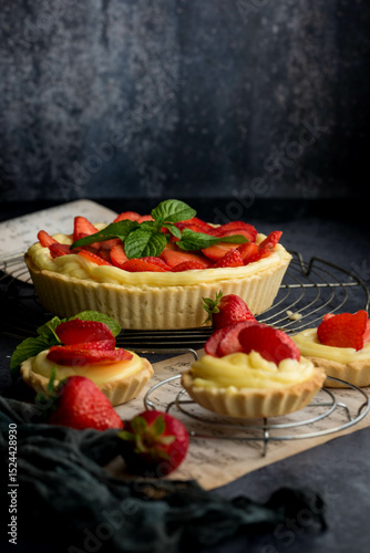 Homemade Strawberry Tart with Cream and Mint on Rustic Background
