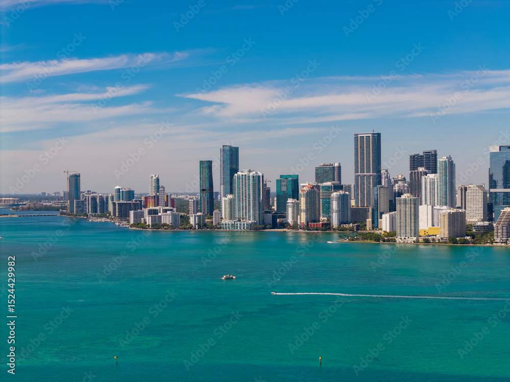Fototapeta premium Skyscraper in downtown city. Cityscape skyline. Brickell building in Miami downtown. Brickell skyline and skyscraper architecture. City skyline. Miami from Brickell Key in Florida. Travel destination