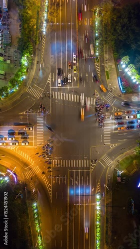 night time illuminated sanya city traffic street crossroad aerial vertical topdown panorama timelapse 4k china