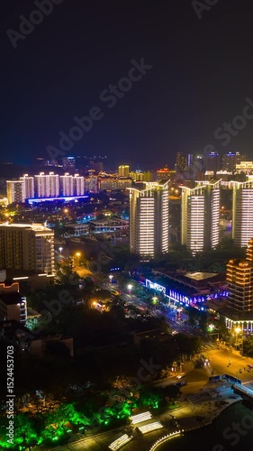 night illumination sanya city riverside bay traffic street aerial vertical panorama timelapse 4k china