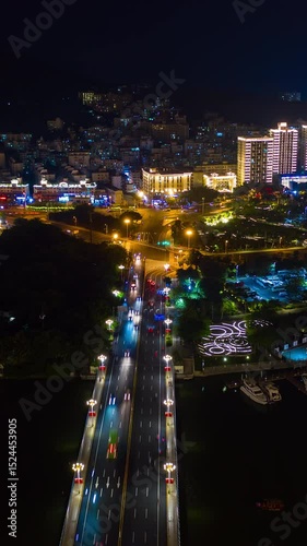 night illumination sanya city traffic street aerial vertical panorama timelapse 4k china