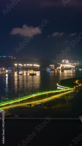 night illumination sanya city bay bridge famous island luxury hotel aerial vertical panorama timelapse 4k china