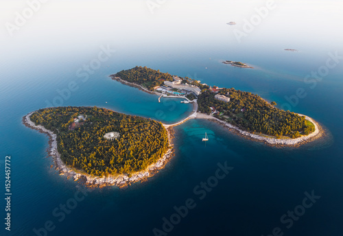 Fototapeta Naklejka Na Ścianę i Meble -  Stunning aerial view of Rovinj's islands at sunrise showcasing natural beauty and tranquility