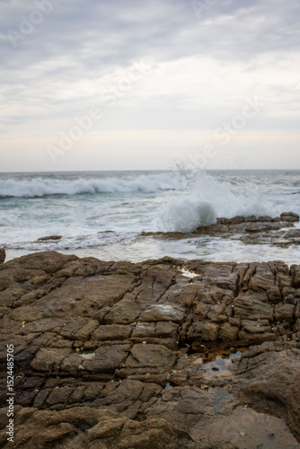 Fototapeta Naklejka Na Ścianę i Meble -  Various waves from the ocean crashing onto the rocks on the south coast of South Africa, located at Orange Rocks in Uvongo in Margate