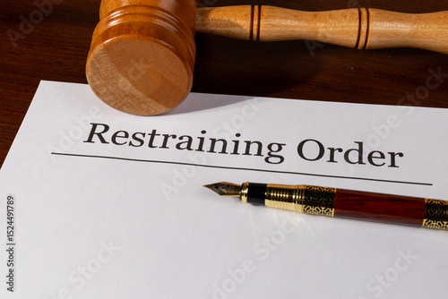Restraining Order Document on the Desk with Gavel and Pen – Legal Protection and Court Order Concept


