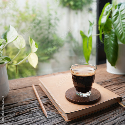 Coffee and notebook by the window