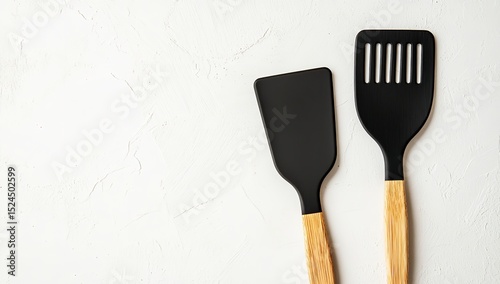 Top View of Black and Wooden Spatula Isolated on White Background – Minimal Kitchen Concept with Copy Space