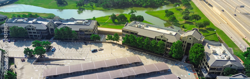 Panorama aerial view shade structure covered parking carport canopy, commercial rooftop HVAC package units of office space for rent, riverside leasing corporate campus in Las Colinas, Irving, TX