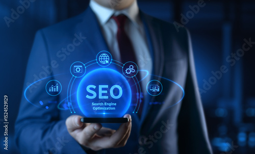 Businessman holding smartphone with Search Engine Optimization SEO icons on screen - Digital Marketing Concept