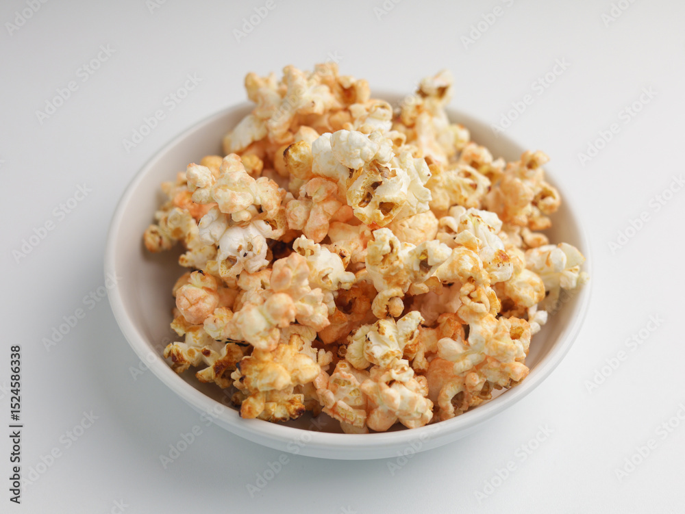 Popcorns on white bowl, isolated on white Popcorns on white bowl, isolated on white