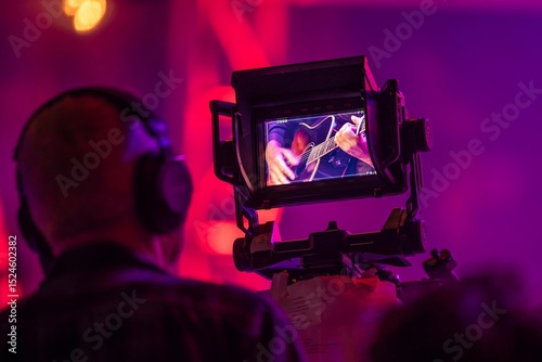 Viewfinder of TV camera at a live concert, framing a closeup shot of a guitar