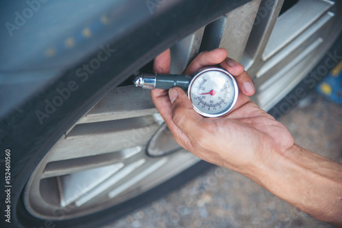 Mechanic man hands checking car tires outdoor on site service auto garage for automotive mobile center services. Technician workshop repair checking tyres car motor vehicles service mechanical hands
