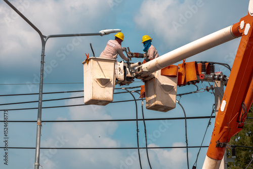 Close-up of Utility Workers on Boom Lift with Street Light
