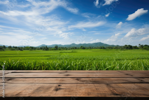 Wooden table on rice fields with blue sky empty