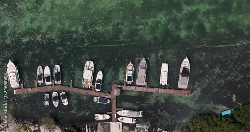 overhead view of boats in a marina, with a small dock.
