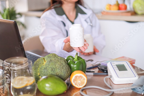 Nutritionist shows jars with dietary supplements against the background of healthy products. Mockup. Vitamin E, antioxidants, omega 3, magnesium, zinc. Dietetics concept, fitness.