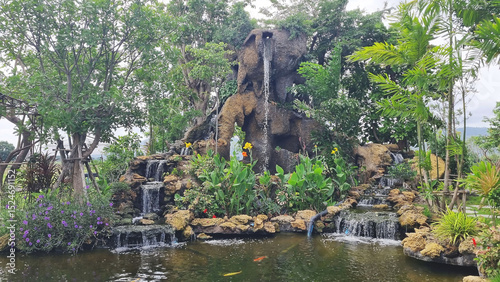 Photo of an artificial waterfall in a public park designed by PTT gas station, Thailand, to provide customers with a place to relax while traveling.