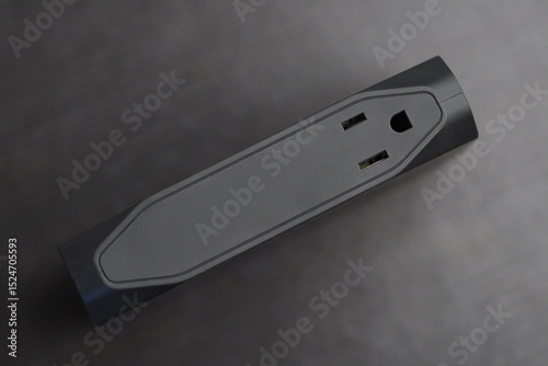 Portable power bank with outlet on a desk.