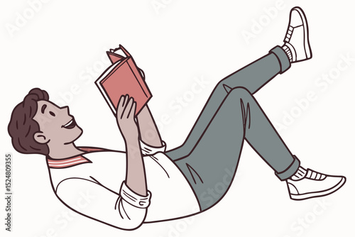 Young man lying down reading a book