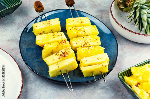 Pineapple on wooden skewer, food photography.