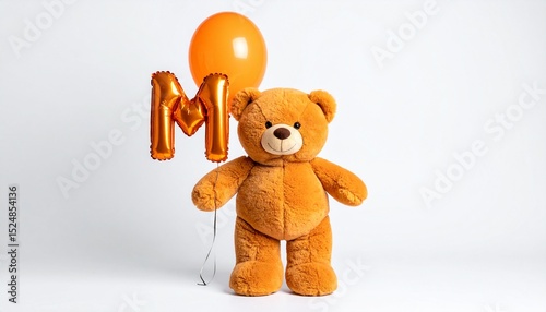 Cute orange teddy bear with balloon letter M. Baby name reveal after child birth. Stuffed animal isolated on white background