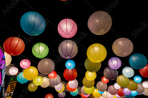 images of lanterns lit in the night. These are chineese colorful baloons which are used for decorating large space. beautiful colors with vibrant environment.