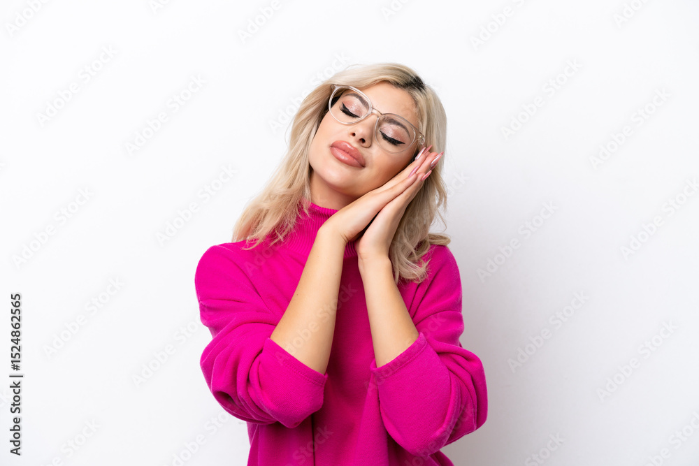 Young Russian woman isolated on white background making sleep gesture in dorable expression Young Russian woman isolated on white background making sleep gesture in dorable expression