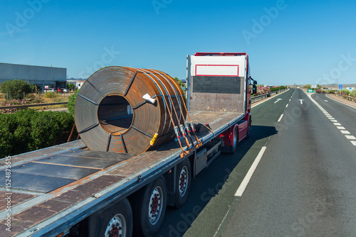 Steel coil on a semi-trailer specially designed for its safe transport by road.