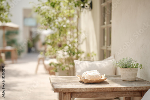 charming outdoor europeanstyle cafe featuring simple wooden table elegantly set with single piece of craft paper photo