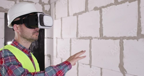 Engineer in virtual reality glasses analyzes room before work. Specialist uses modern headset to quickly process information about features of renovated building