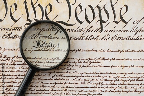 American USA Constitution paper page and magnifying glass close up