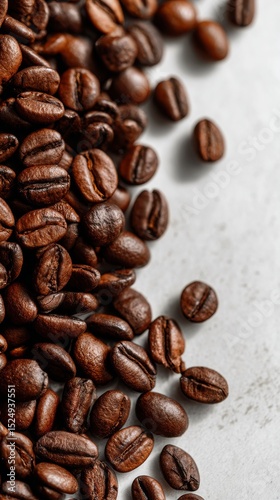 Freshly Roasted Coffee Beans Scattered on a Light Surface for a Rich and Arom...