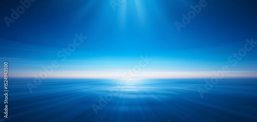 Calm ocean horizon with peaceful blue water and radiant sunlight rays shining down