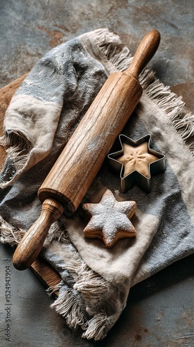 Rolling Pin and Star Shaped Cookies on a Textured Cloth in a Rustic Kitchen S...