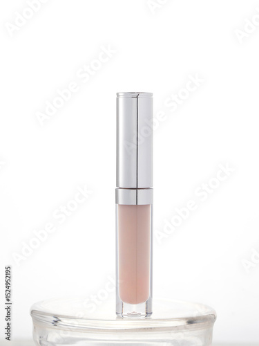 Sleek transparent cosmetic container with metallic cap, ideal for lip gloss, concealer, or serum. Clean, professional presentation for beauty product advertising or branding.