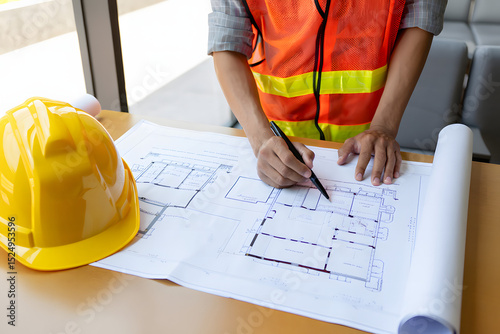 Architect and construction engineer with blueprints planning a building project, construction worker with blueprints