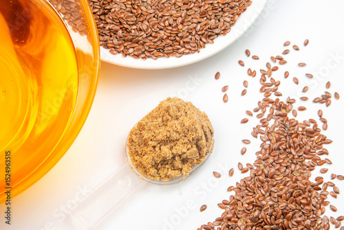 ground flaxseed and oil on white background