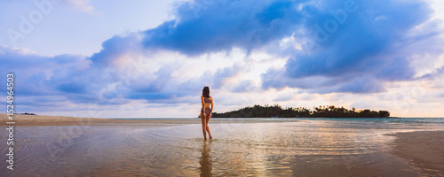 Happy traveler asian woman with bikini relax on sea Klong Rahan beach in sunset at Koh Kood Trat Thailand Summer travel holiday vacation concept