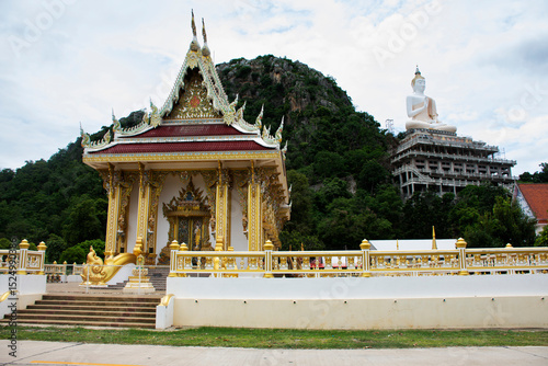 Beautiful ancient ordination hall or antique old ubosot for thai people travelers travel visit respect praying blessing wish holy worship buddha statue at Wat Tham Khao Laem in Kanchanaburi, Thailand