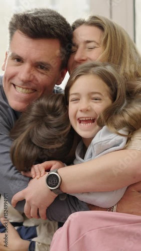 Happy family hugging and kissing at home
