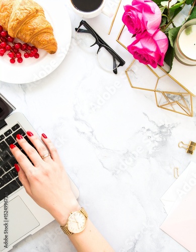 The hands of a young woman operating a laptop computer. Stylish work-from-home image background material