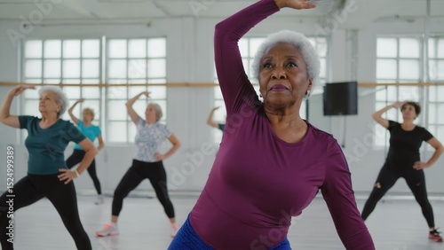 A group of older women are actively doing their exercises in a gym